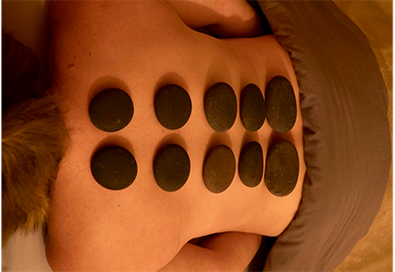 hot stones on person's back